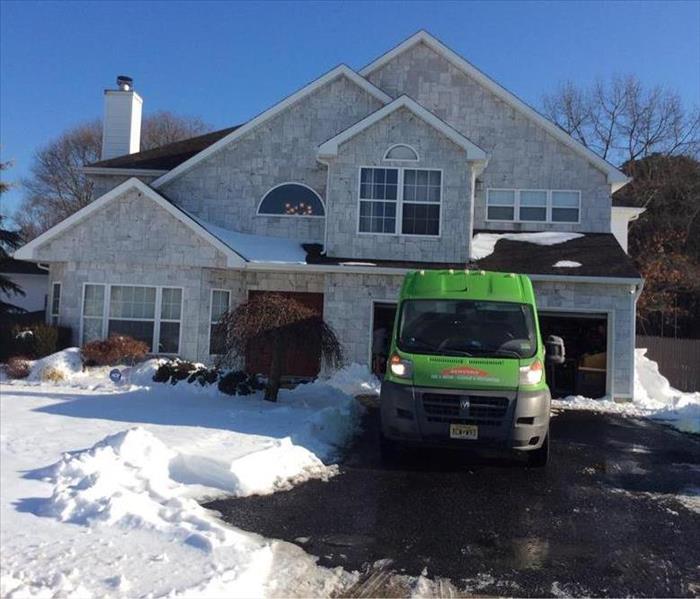 SERVPRO truck in driveway of home with snow