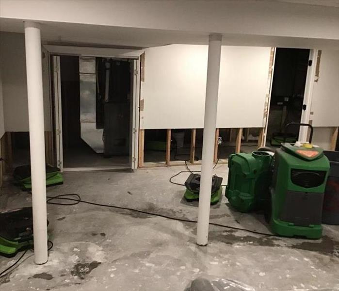 Cut out drywall with air movers and dehumidifier in basement