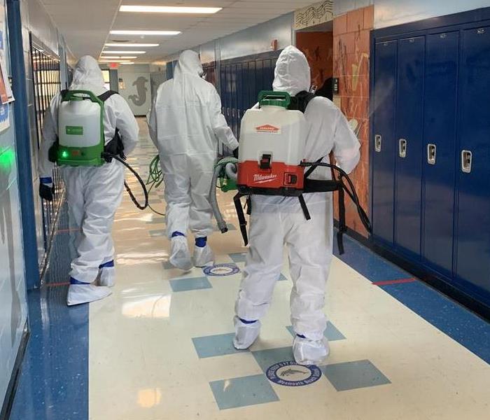 Are those Ghost Busters? Image of group of technicians in PPE.