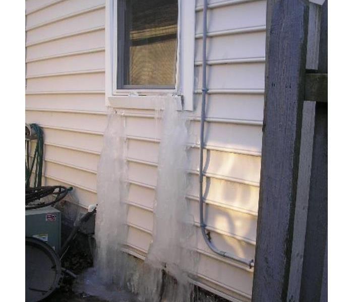 water leaking from window frozen into ice